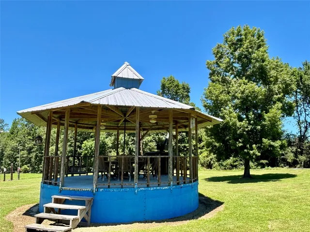 a view of a chairs and an umbrella in the garden