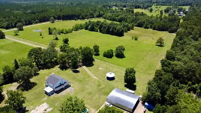 an aerial view of a house with yard swimming pool and outdoor seating