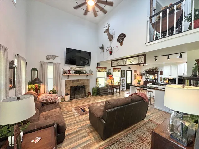 a living room with furniture a flat screen tv and a fireplace