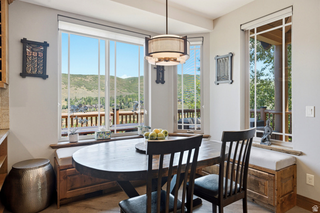 3148 Lower Saddleback Road Park City, UT 84098 - Photo 15 of 67 Breakfast nook featuring an oval wood-finish table with two chairs, built-in bench seating with upholstered cushions, and a multi-pane window array