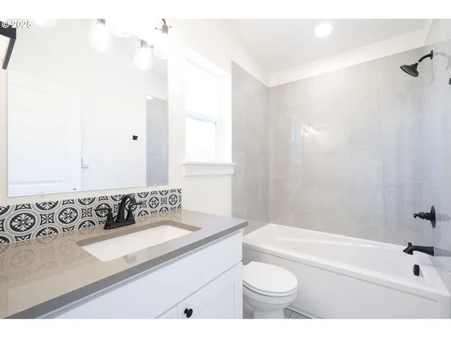 a bathroom with a sink a toilet and a bathtub