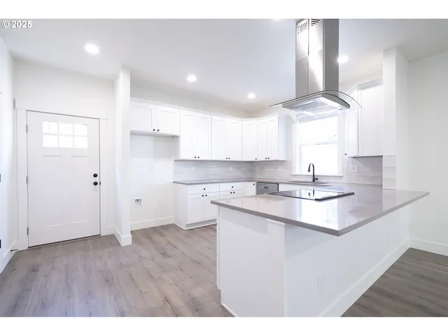 a kitchen with a sink cabinets and window