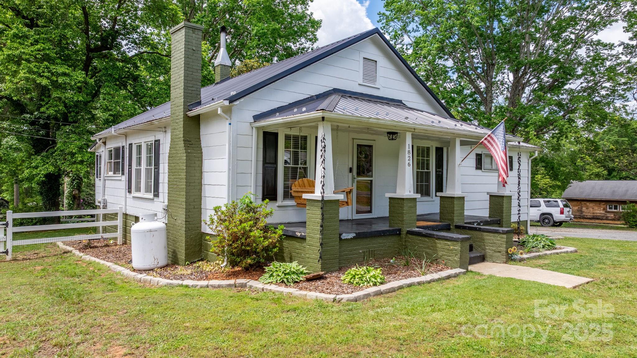 a view of a house with swimming pool and a yard with furniture