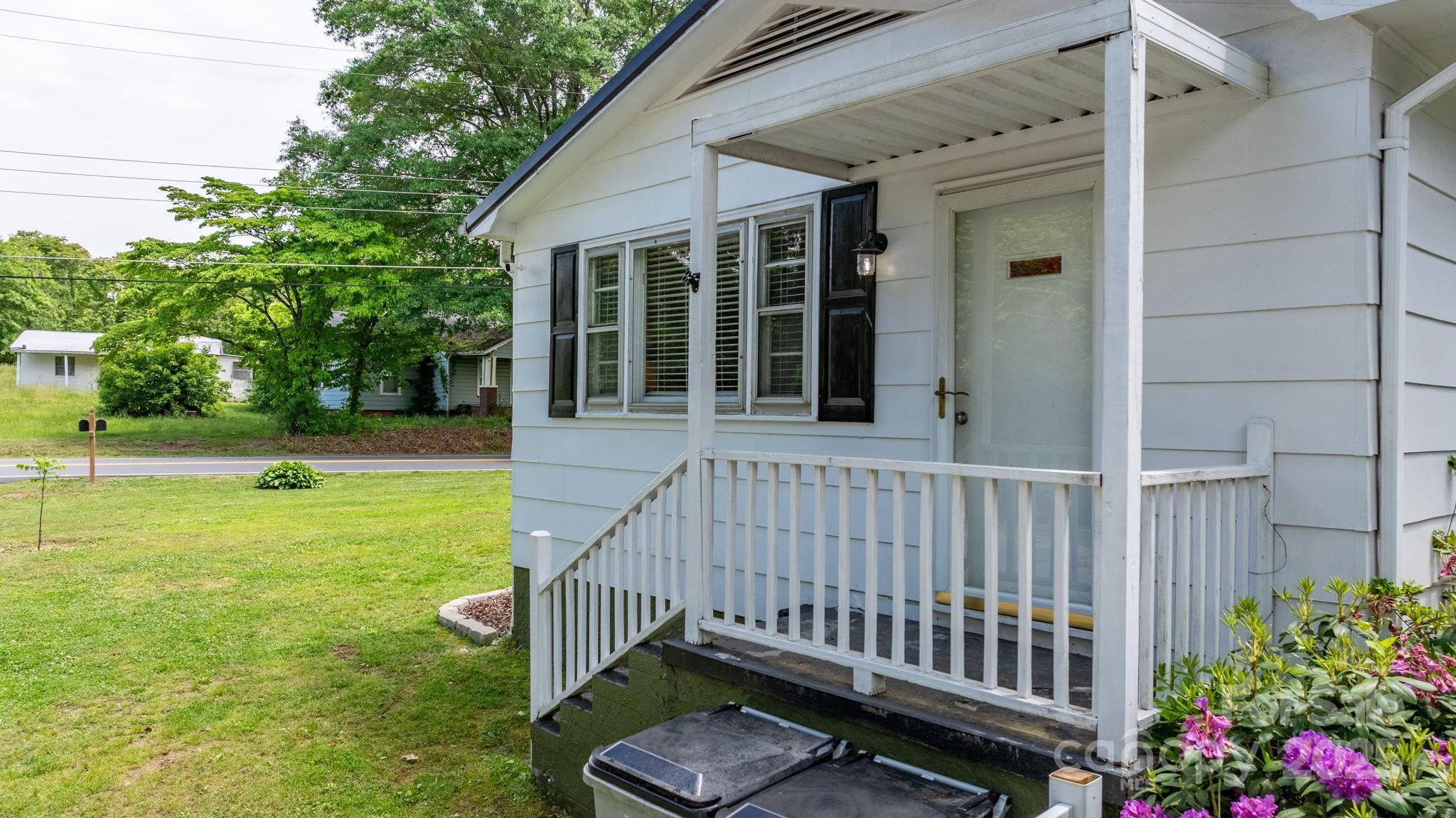 1826 Walt Arney Road Lenoir, NC 28645 - Photo 15 of 40 a view of a backyard with a garden and deck
