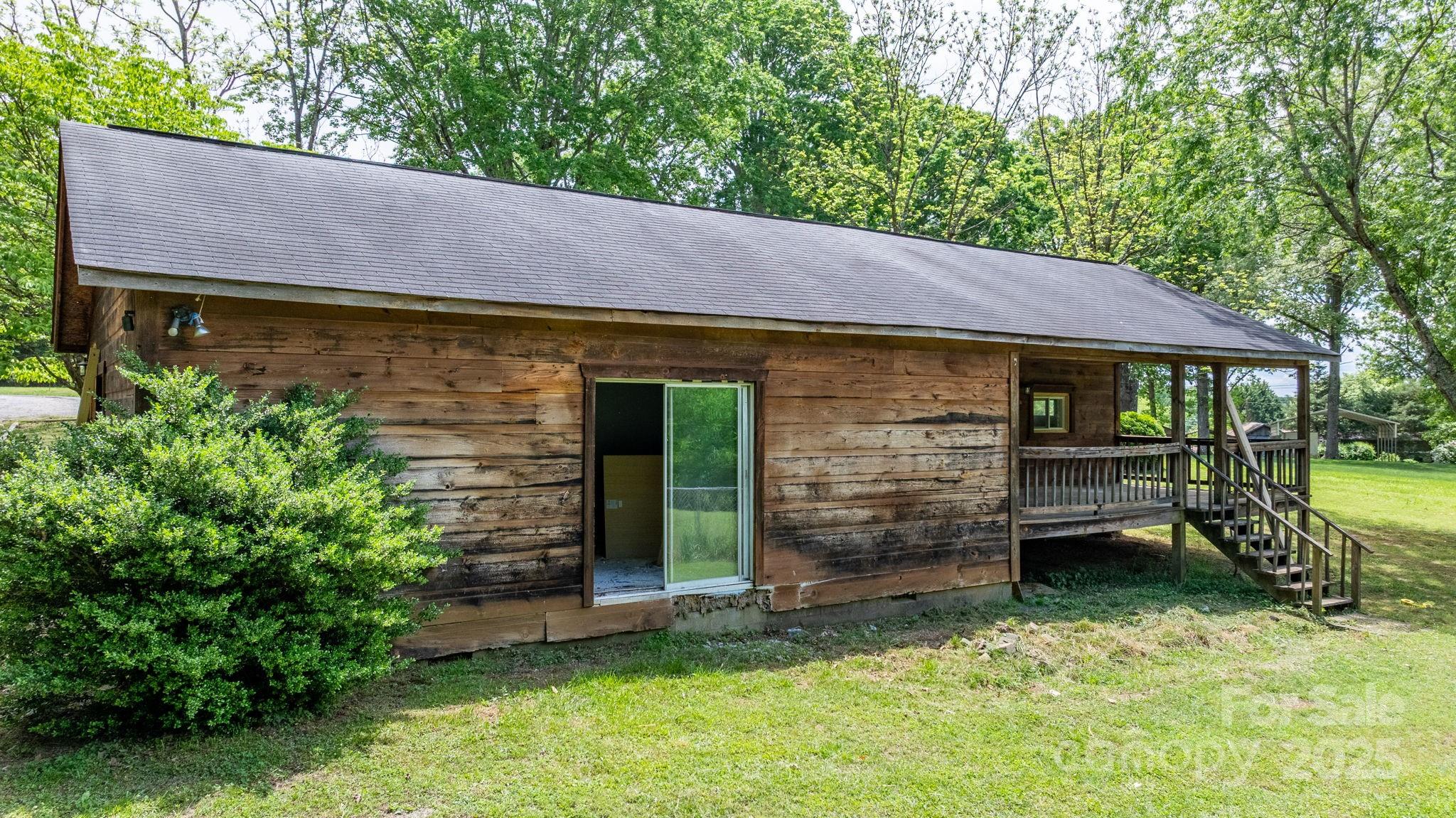 1826 Walt Arney Road Lenoir, NC 28645 - Photo 19 of 40 a backyard of a house with barbeque oven