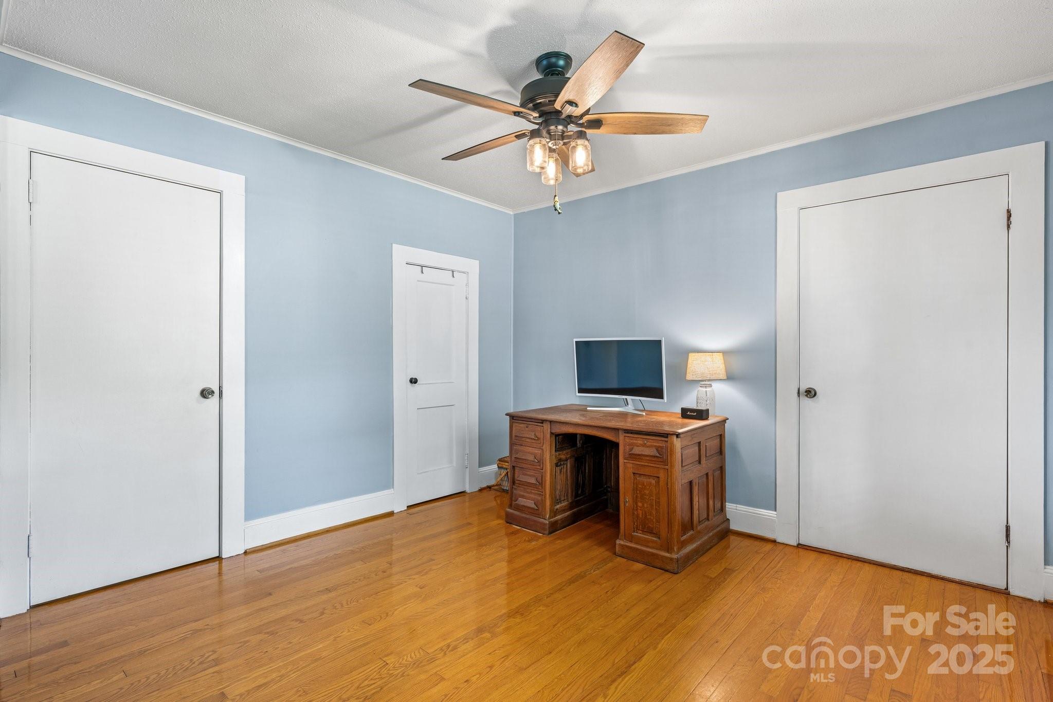 1826 Walt Arney Road Lenoir, NC 28645 - Photo 26 of 40 a view of a workspace with furniture and a ceiling fan