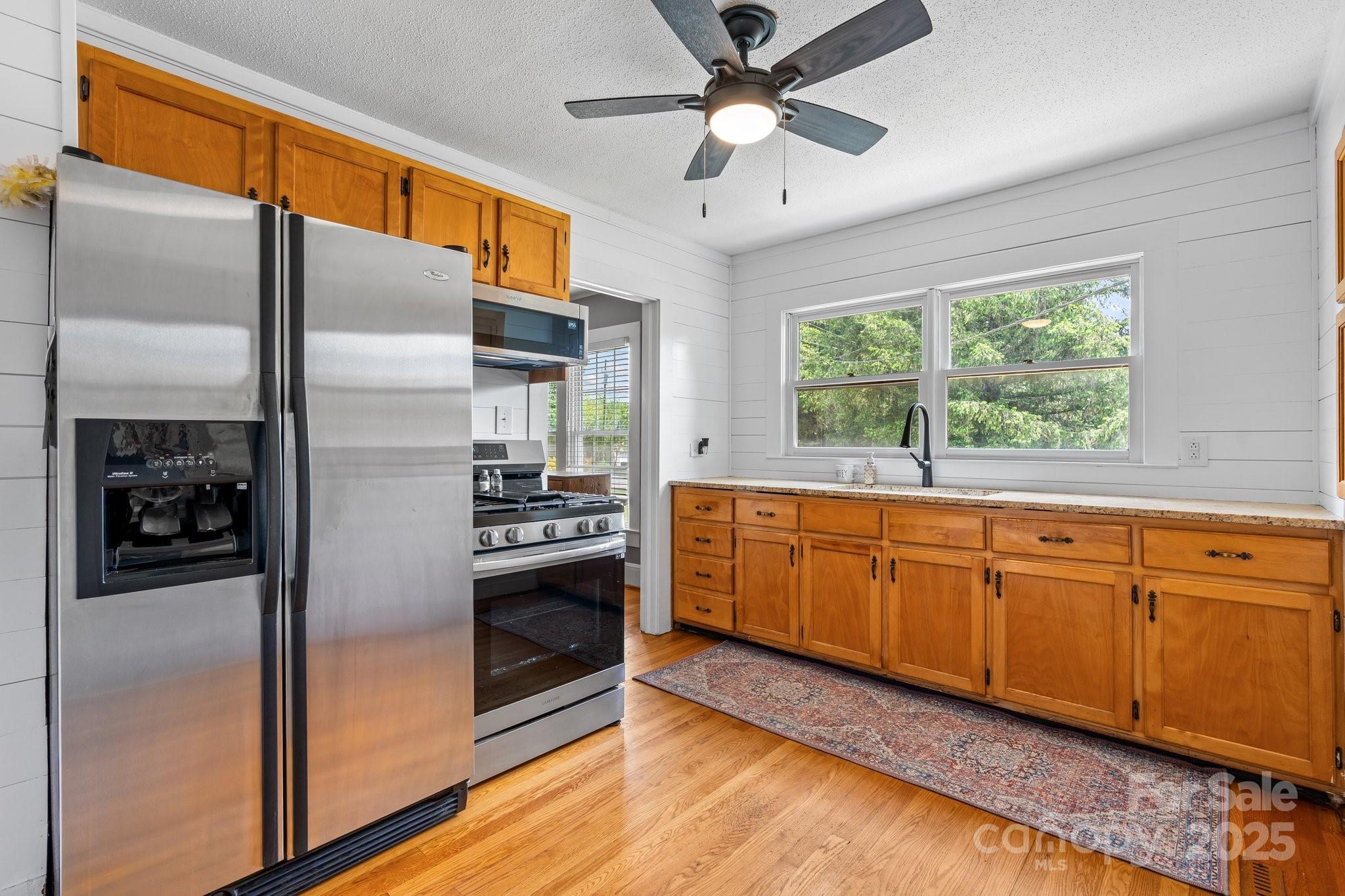 1826 Walt Arney Road Lenoir, NC 28645 - Photo 27 of 40 a kitchen with stainless steel appliances granite countertop a refrigerator a sink a stove and a refrigerator