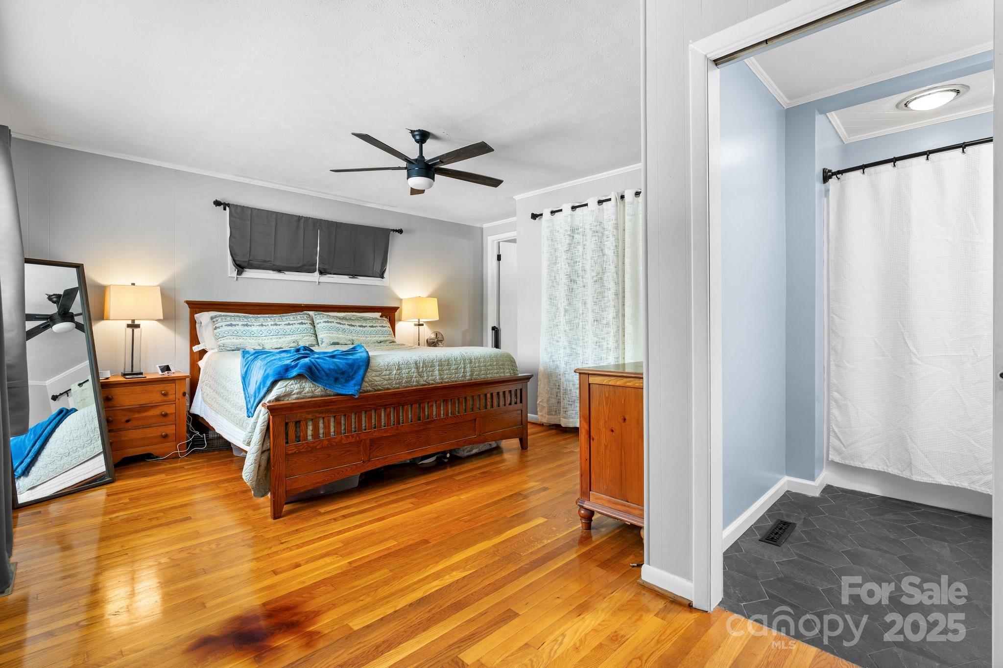 1826 Walt Arney Road Lenoir, NC 28645 - Photo 31 of 40 a bedroom with a bed and a chandelier