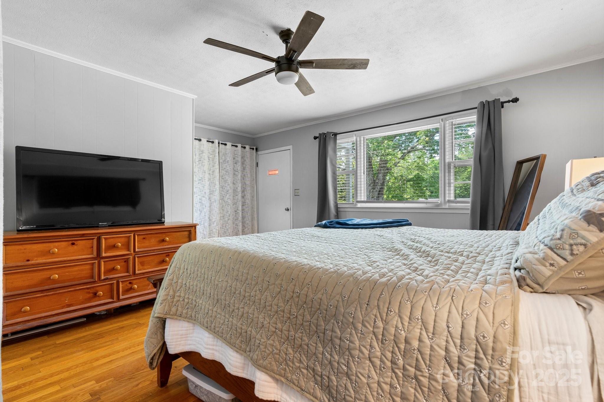 1826 Walt Arney Road Lenoir, NC 28645 - Photo 32 of 40 a bedroom with a bed and a flat screen tv