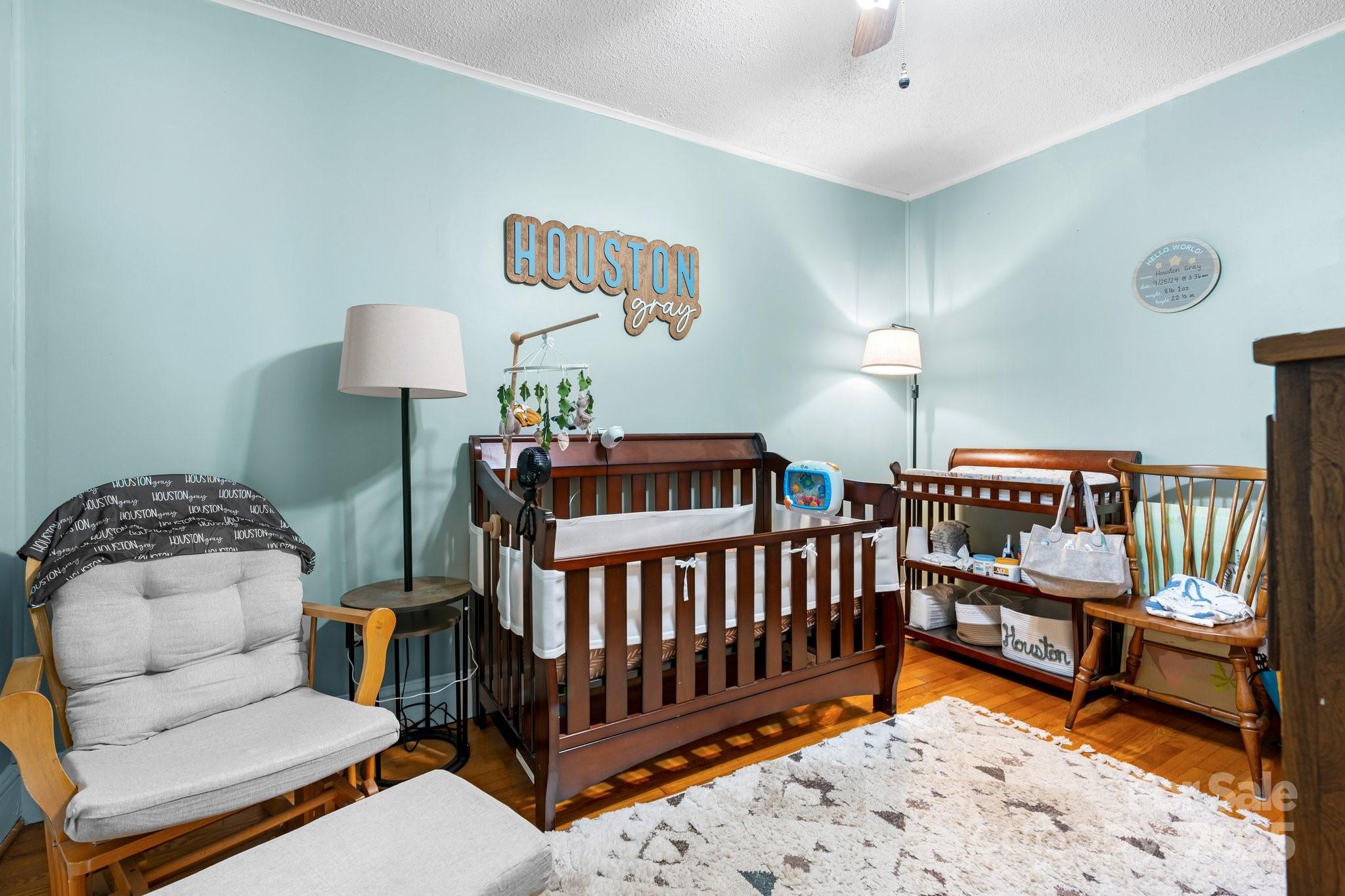 1826 Walt Arney Road Lenoir, NC 28645 - Photo 34 of 40 a bedroom with furniture and a baby crib