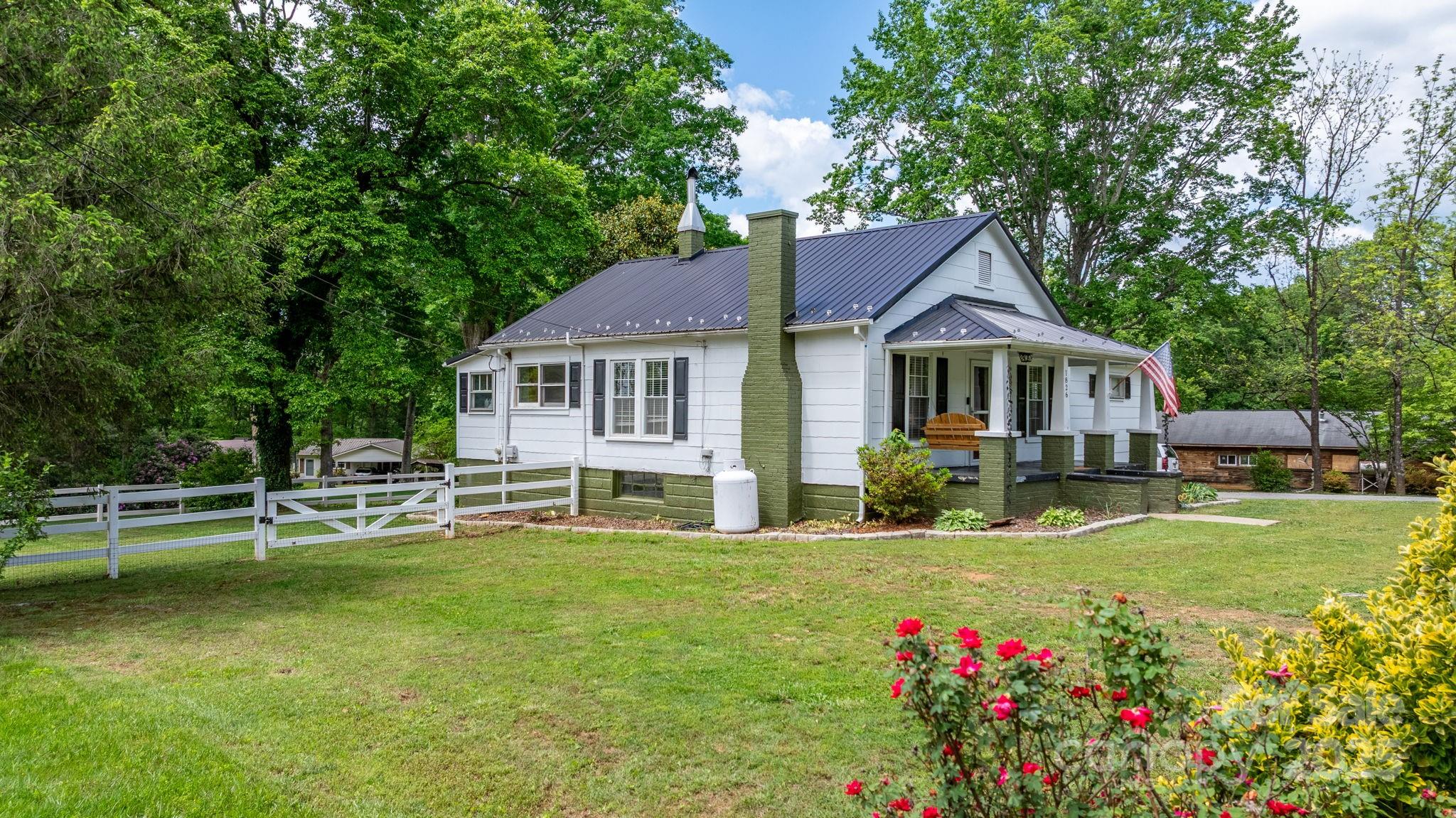 1826 Walt Arney Road Lenoir, NC 28645 - Photo 4 of 40 a house view with a sitting space and garden