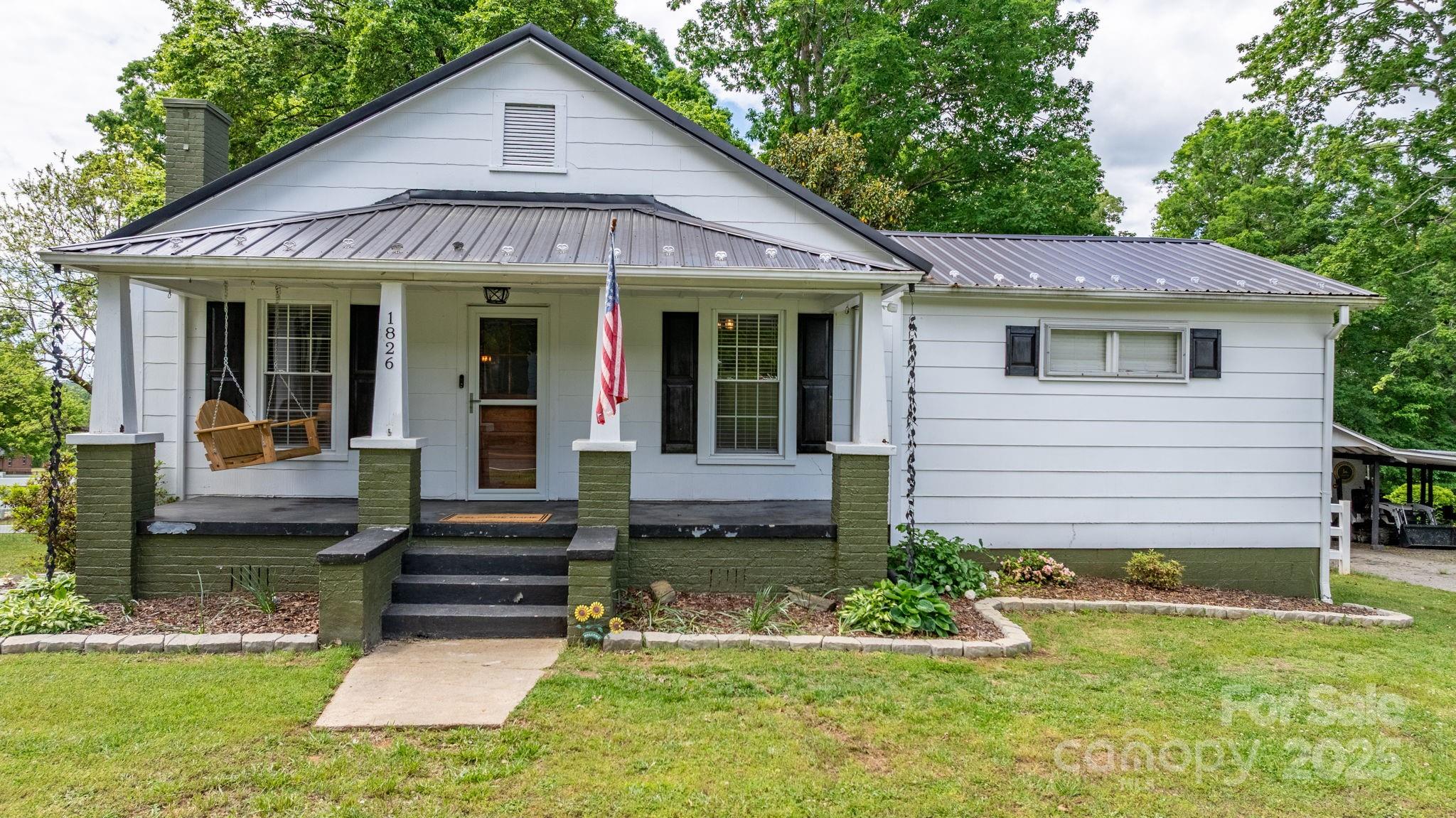 1826 Walt Arney Road Lenoir, NC 28645 - Photo 5 of 40 a front view of a house with a yard