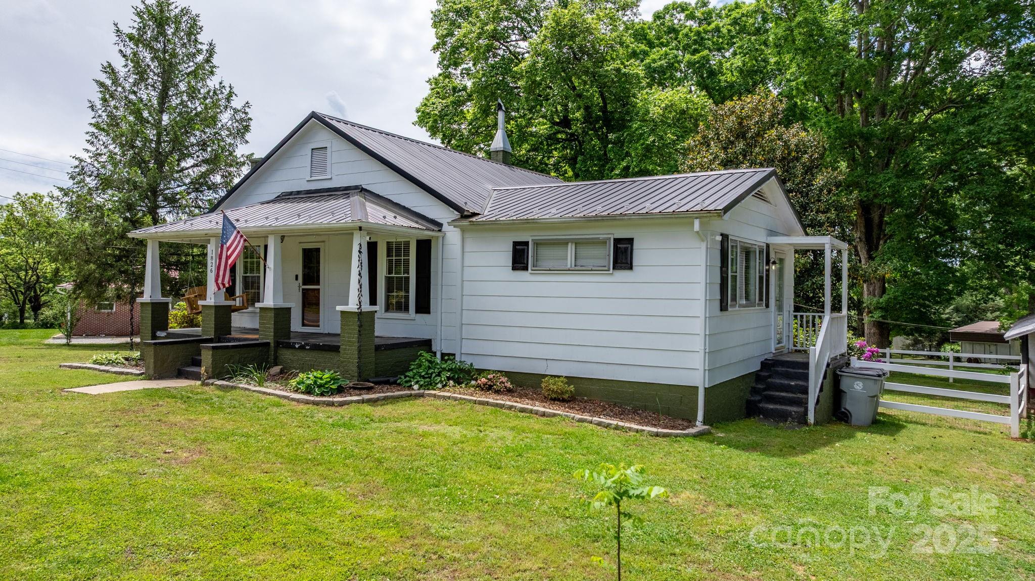 1826 Walt Arney Road Lenoir, NC 28645 - Photo 7 of 40 a view of a house with a yard chairs and a table and chairs