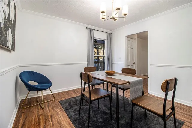 a view of a dining room with furniture and wooden floor