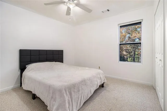 a large bed sitting in a bedroom next to a window