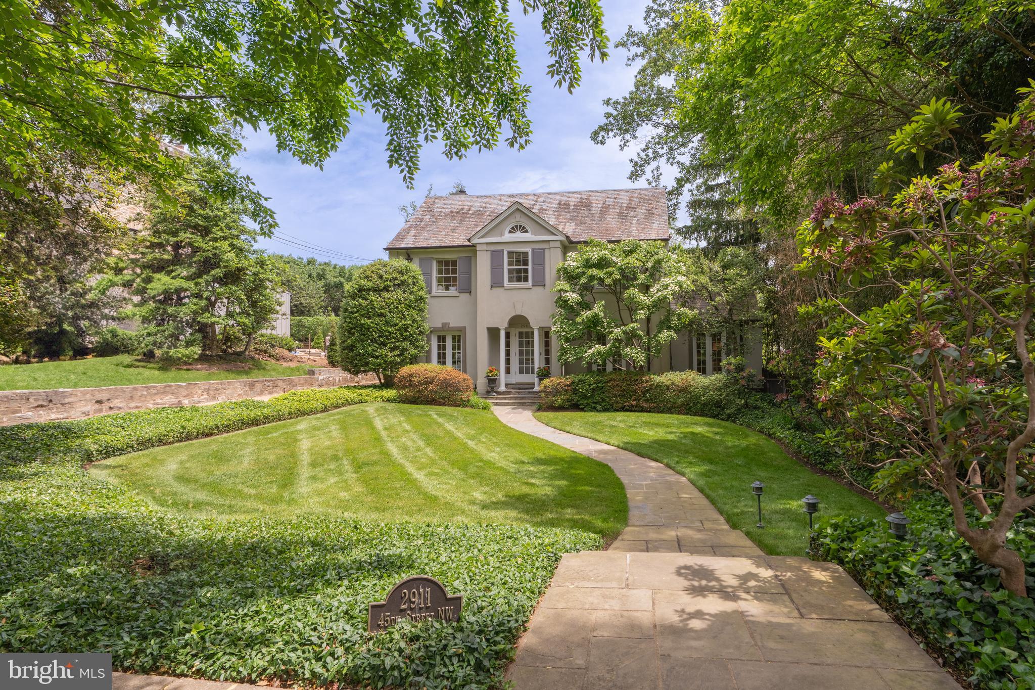 a view of a house with swimming pool and a yard
