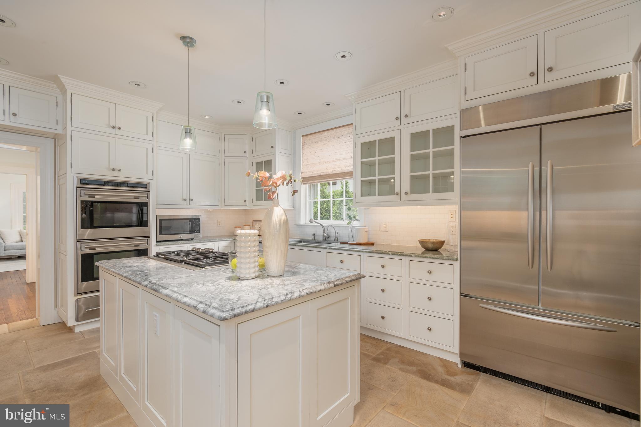 2911 45th Street Northwest Washington, DC 20016 - Photo 12 of 49 a kitchen with stainless steel appliances granite countertop a sink stove and refrigerator