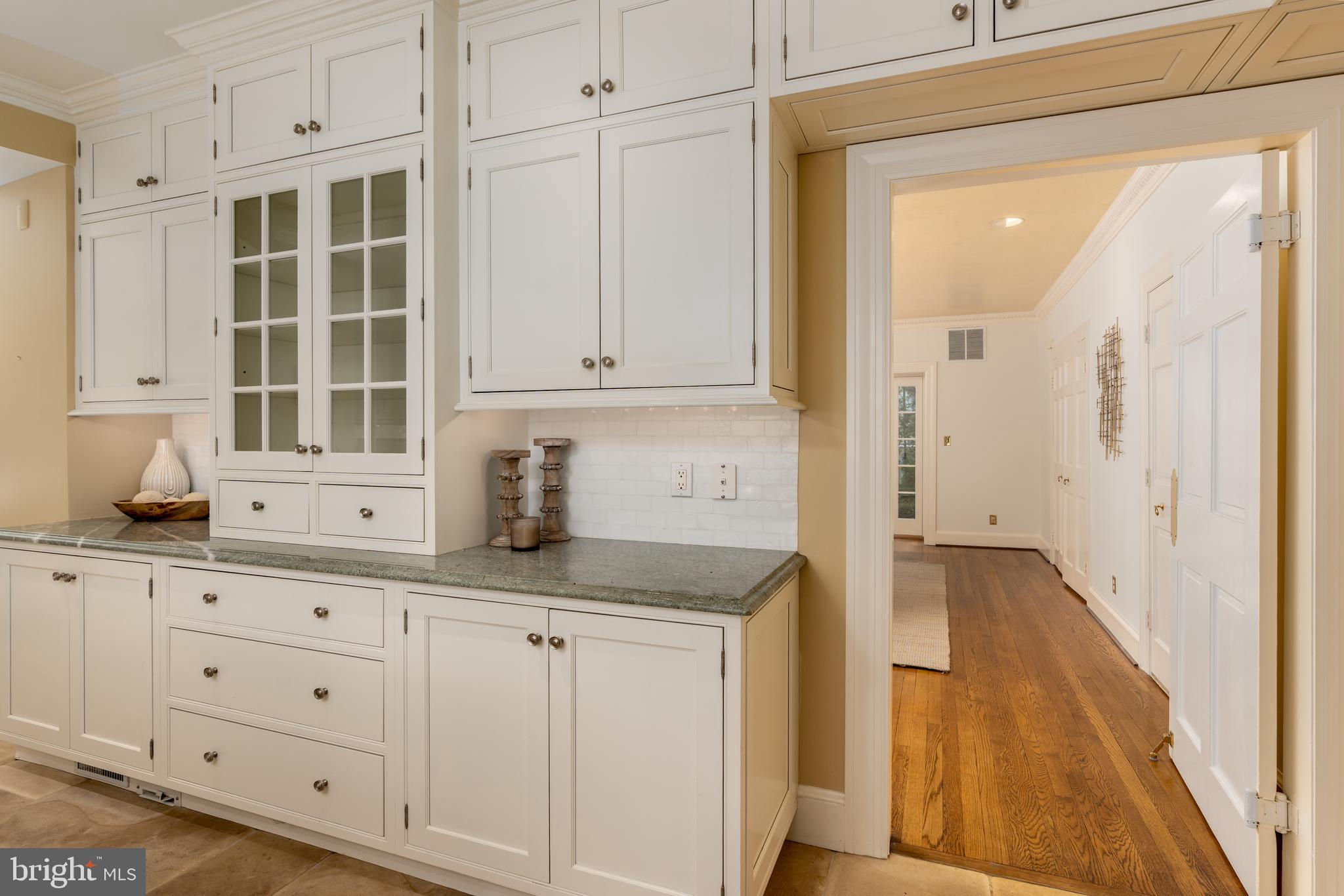 2911 45th Street Northwest Washington, DC 20016 - Photo 16 of 49 a kitchen with granite countertop white cabinets and sink