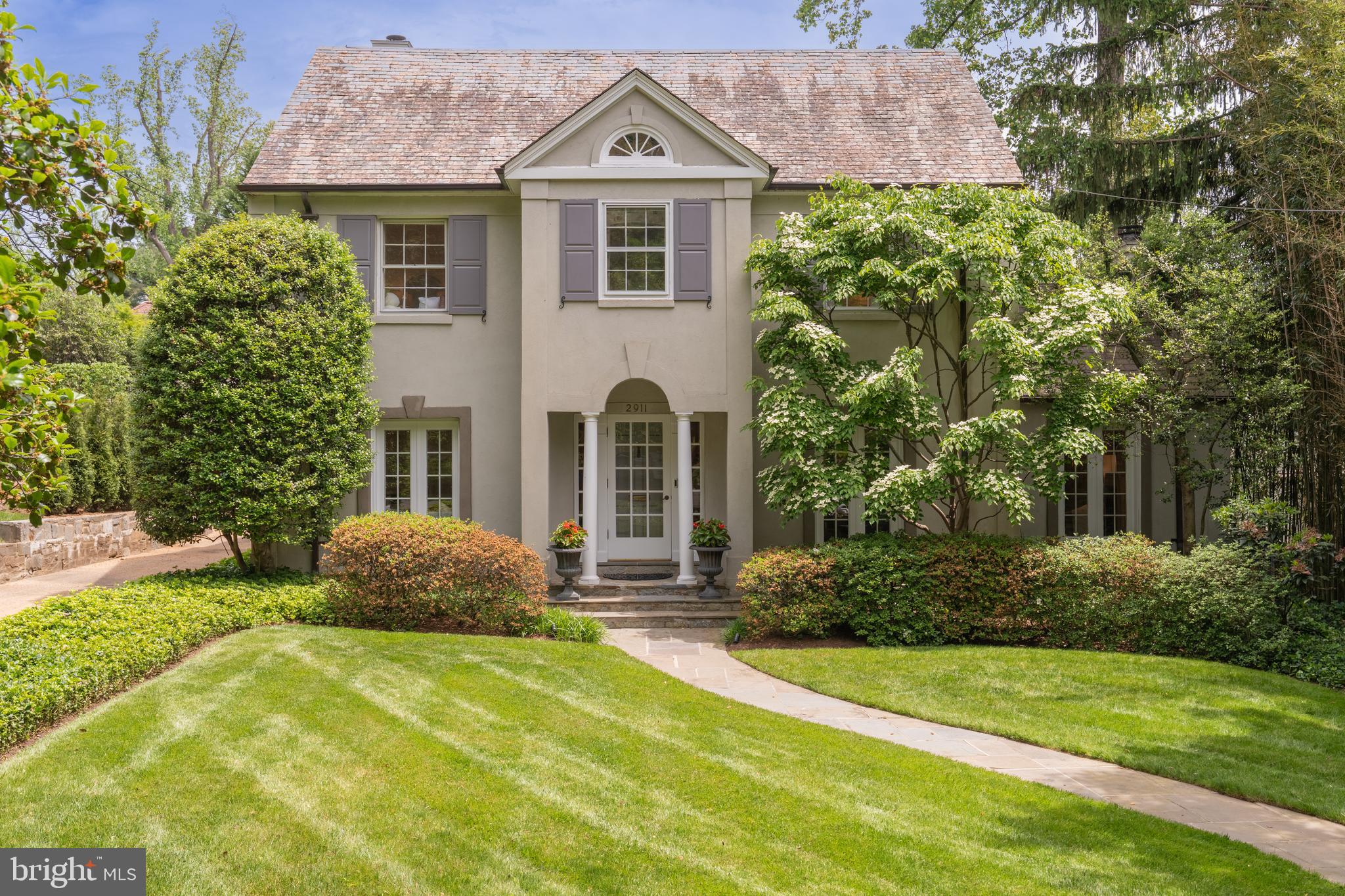 2911 45th Street Northwest Washington, DC 20016 - Photo 3 of 49 a front view of a house with a yard and garage