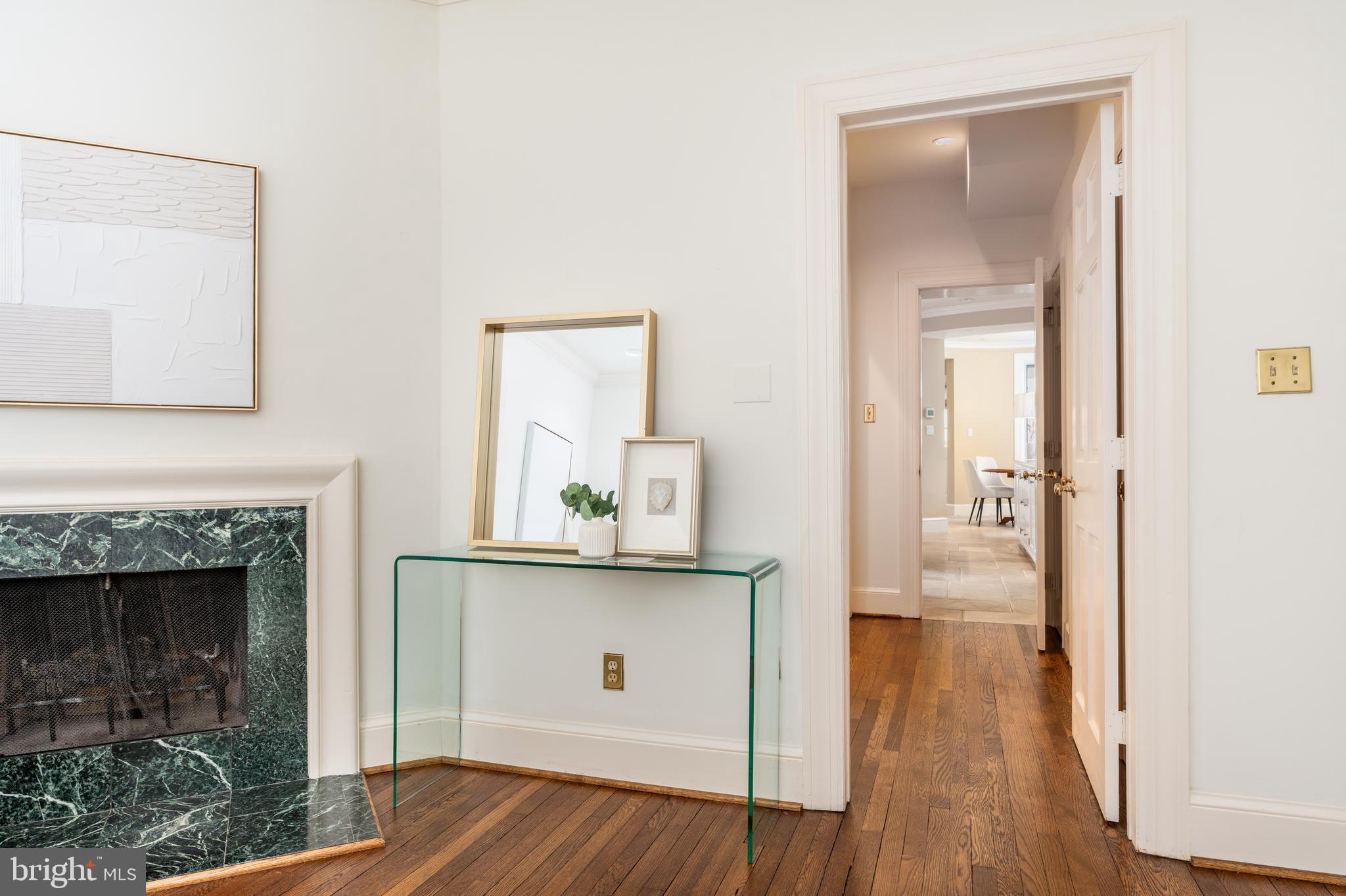 2911 45th Street Northwest Washington, DC 20016 - Photo 7 of 49 a view of a hallway with wooden floor and a fireplace