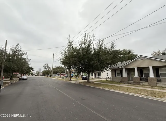 a view of a street with houses on the road