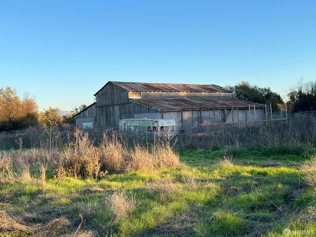a view of a house with a yard next to a lake view