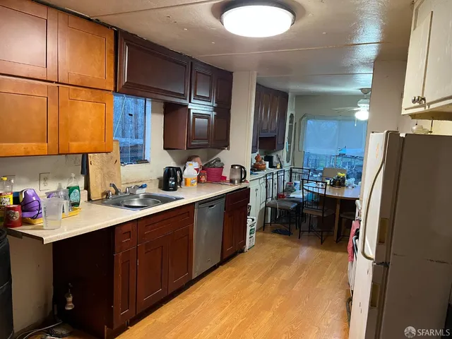 a kitchen with refrigerator cabinets and a sink