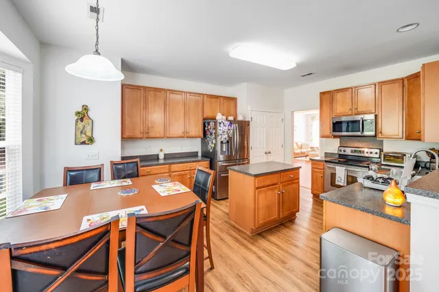 a bedroom with a bed and a dresser with mirror