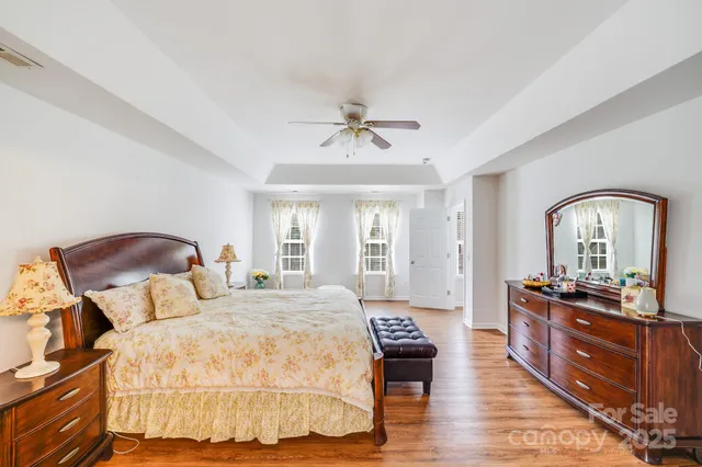 a bedroom with a bed and a dresser with mirror