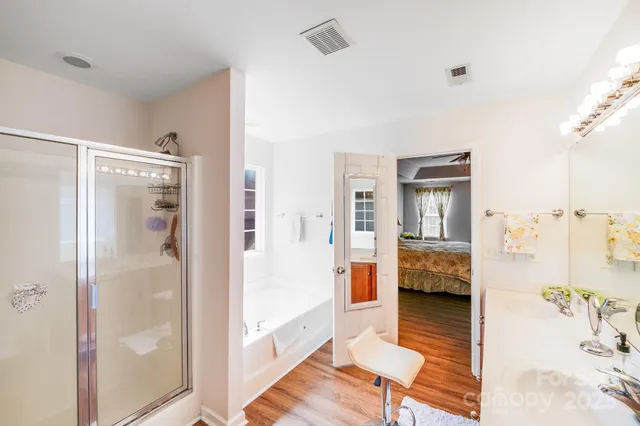 a view of a bathroom with tub and shower