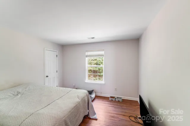 a spacious bedroom with a bed and a window