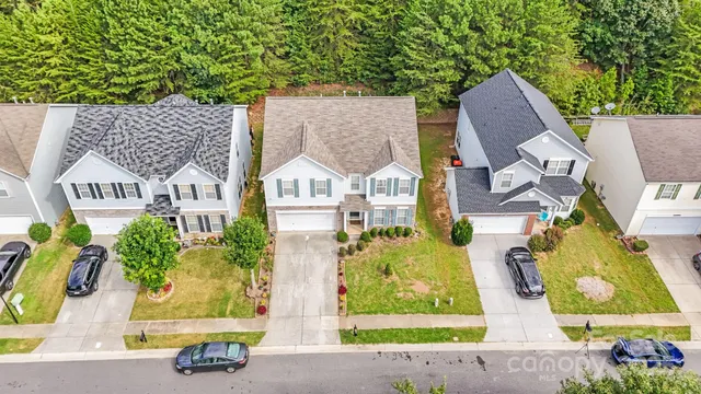 an aerial view of residential house with outdoor space and swimming pool