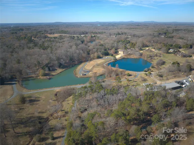 a kitchen with stainless steel appliances granite countertop a stove a sink dishwasher and a refrigerator with wooden floor
