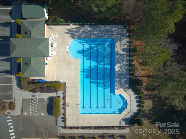 a kitchen with stainless steel appliances granite countertop a stove top oven a sink dishwasher a dining table and chairs with wooden floor