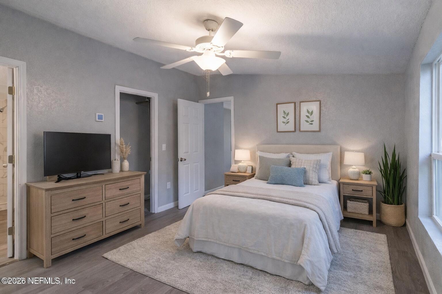 3245 Byo Road Jacksonville, FL 32207 - Photo 13 of 25 a bedroom with a bed a mirror and a flat tv screen on dresser