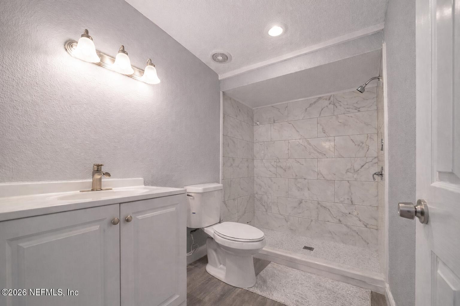 3245 Byo Road Jacksonville, FL 32207 - Photo 16 of 25 a bathroom with a sink toilet a mirror and shower