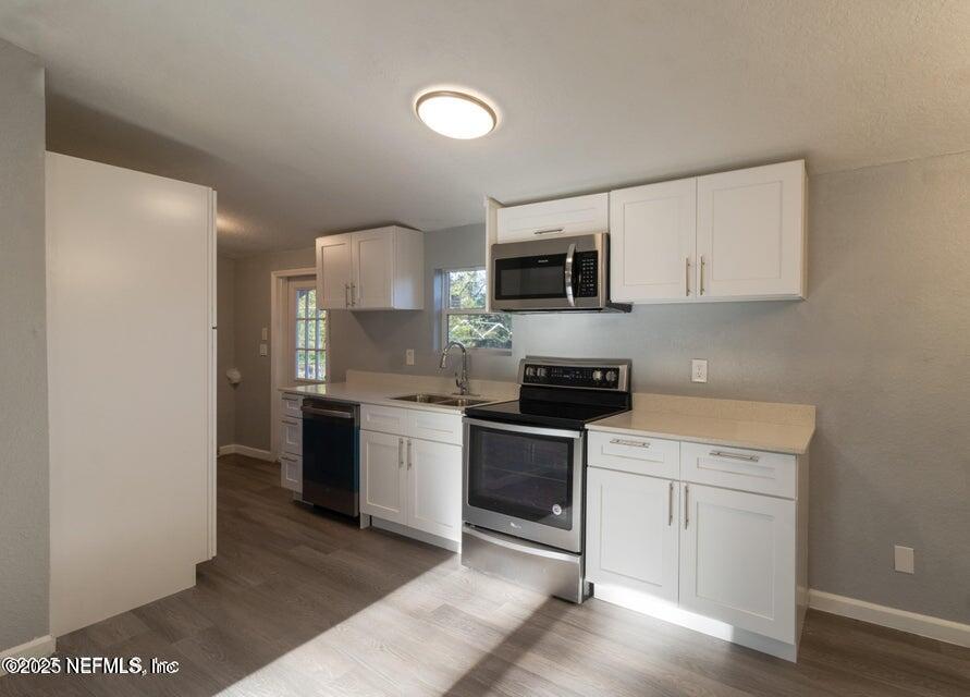 3245 Byo Road Jacksonville, FL 32207 - Photo 20 of 25 a kitchen with a sink stove and microwave
