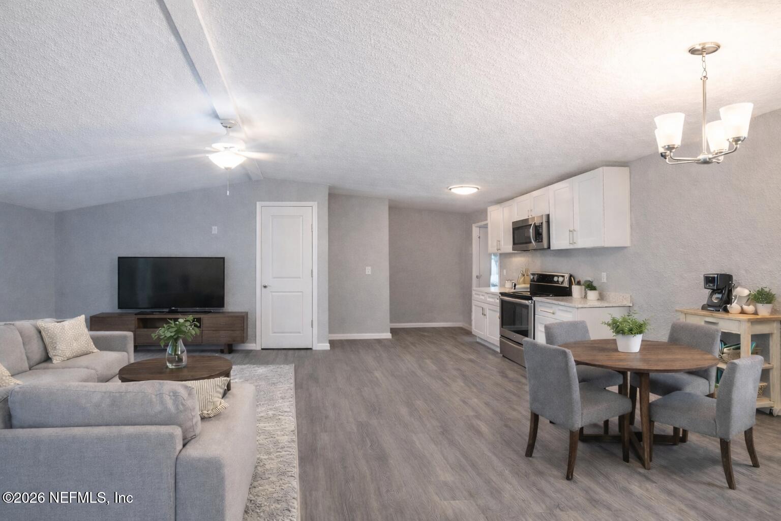 3245 Byo Road Jacksonville, FL 32207 - Photo 3 of 25 a living room with furniture a flat screen tv and kitchen view