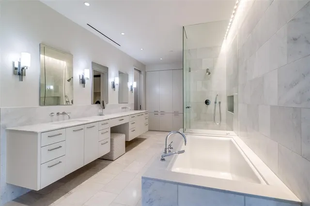 a bedroom with a bed a large window and walk in closet with a large window