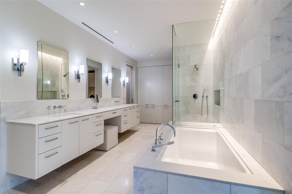 1747 Leonard Street, Unit 802 Dallas, TX 75201 - Photo 13 of 26 a bathroom with a sink double vanity granite tub shower and a mirror