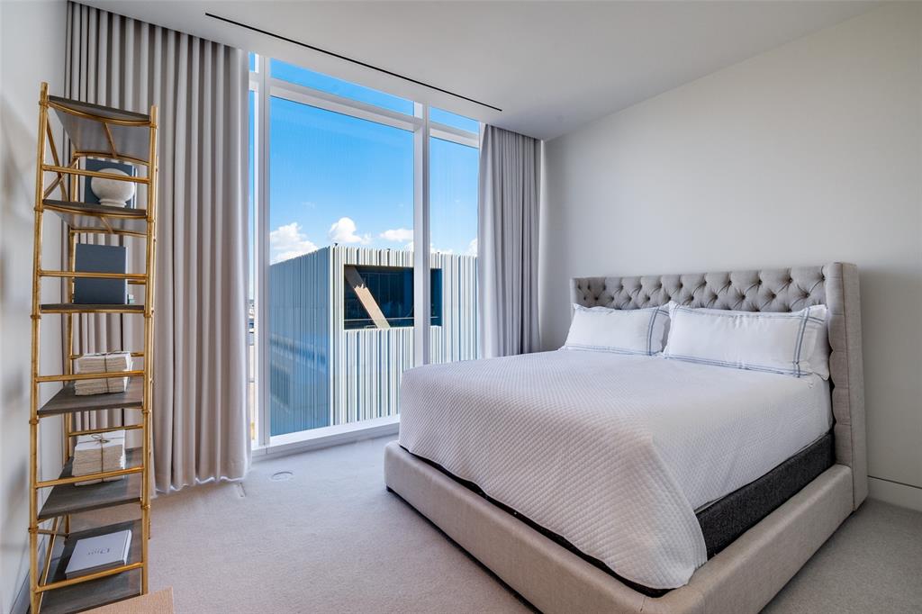 1747 Leonard Street, Unit 802 Dallas, TX 75201 - Photo 15 of 26 a spacious bedroom with a bed and a cabinets