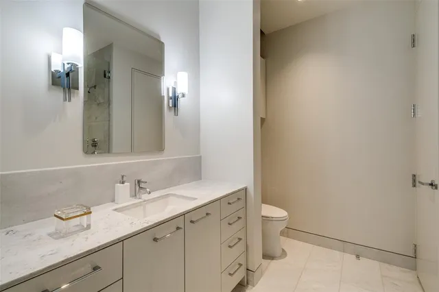 a kitchen with a sink and a wooden floor