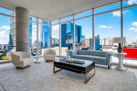 a living room with furniture and a floor to ceiling window