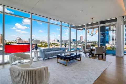 a living room with furniture a rug and a chandelier