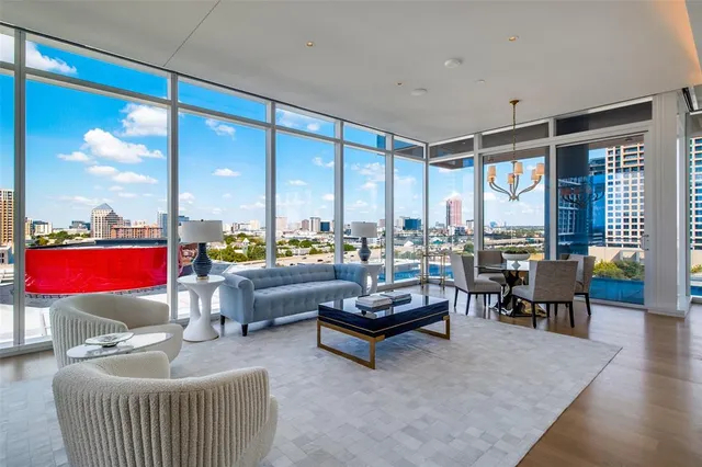 a living room with furniture a rug and a chandelier