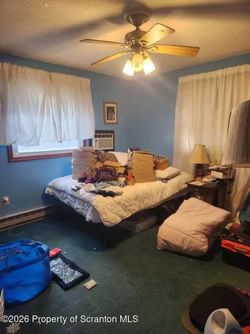 a bedroom with two beds and a potted plant