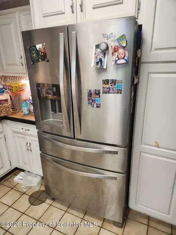 a white refrigerator freezer sitting inside of a kitchen