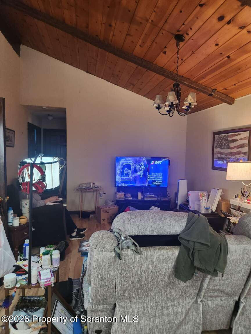 374 Country Road Falls, PA 18615 - Photo 8 of 21 a bedroom with furniture and a chandelier