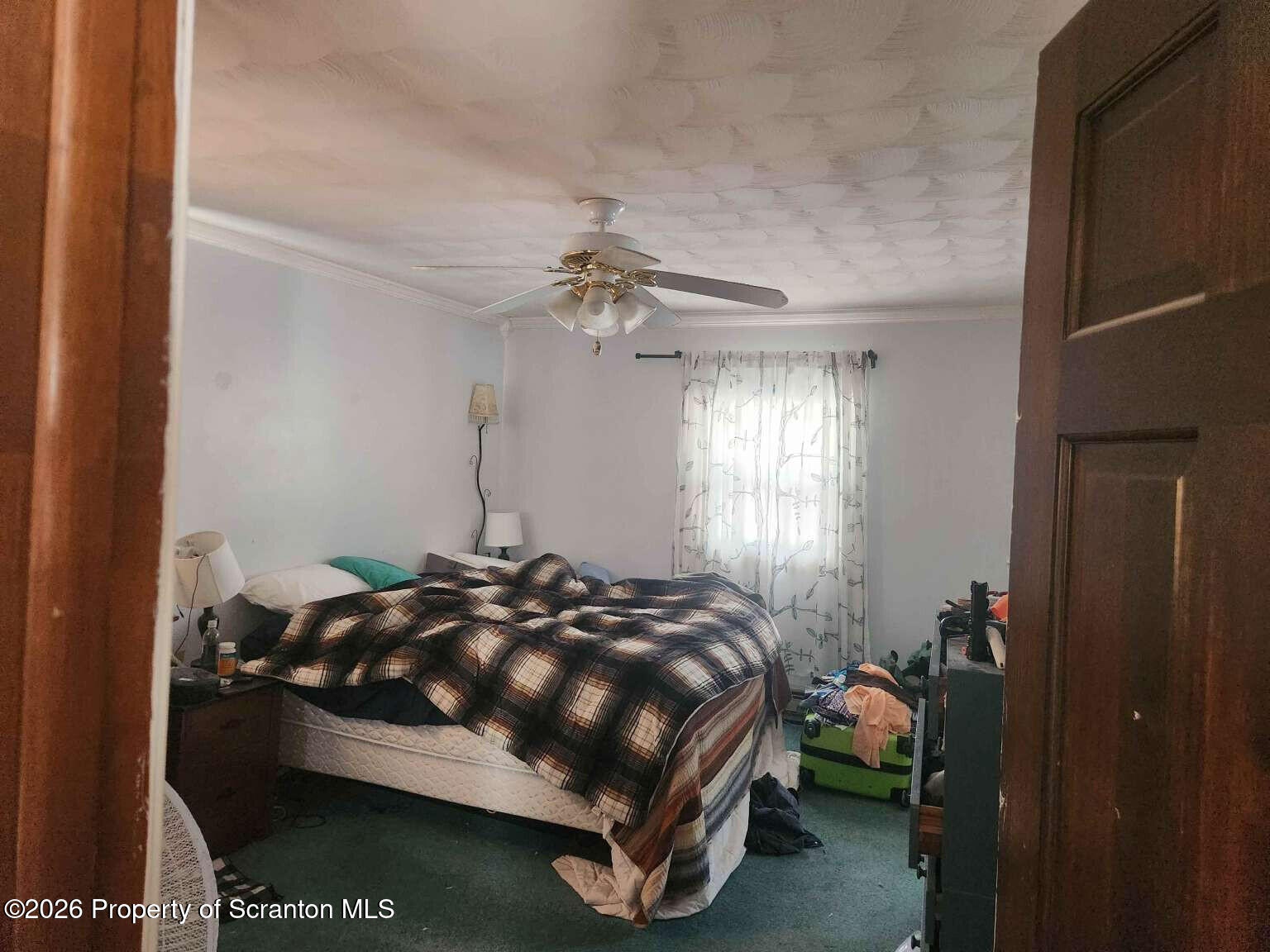 374 Country Road Falls, PA 18615 - Photo 9 of 21 a bed sitting in a bedroom next to a window and a chandelier