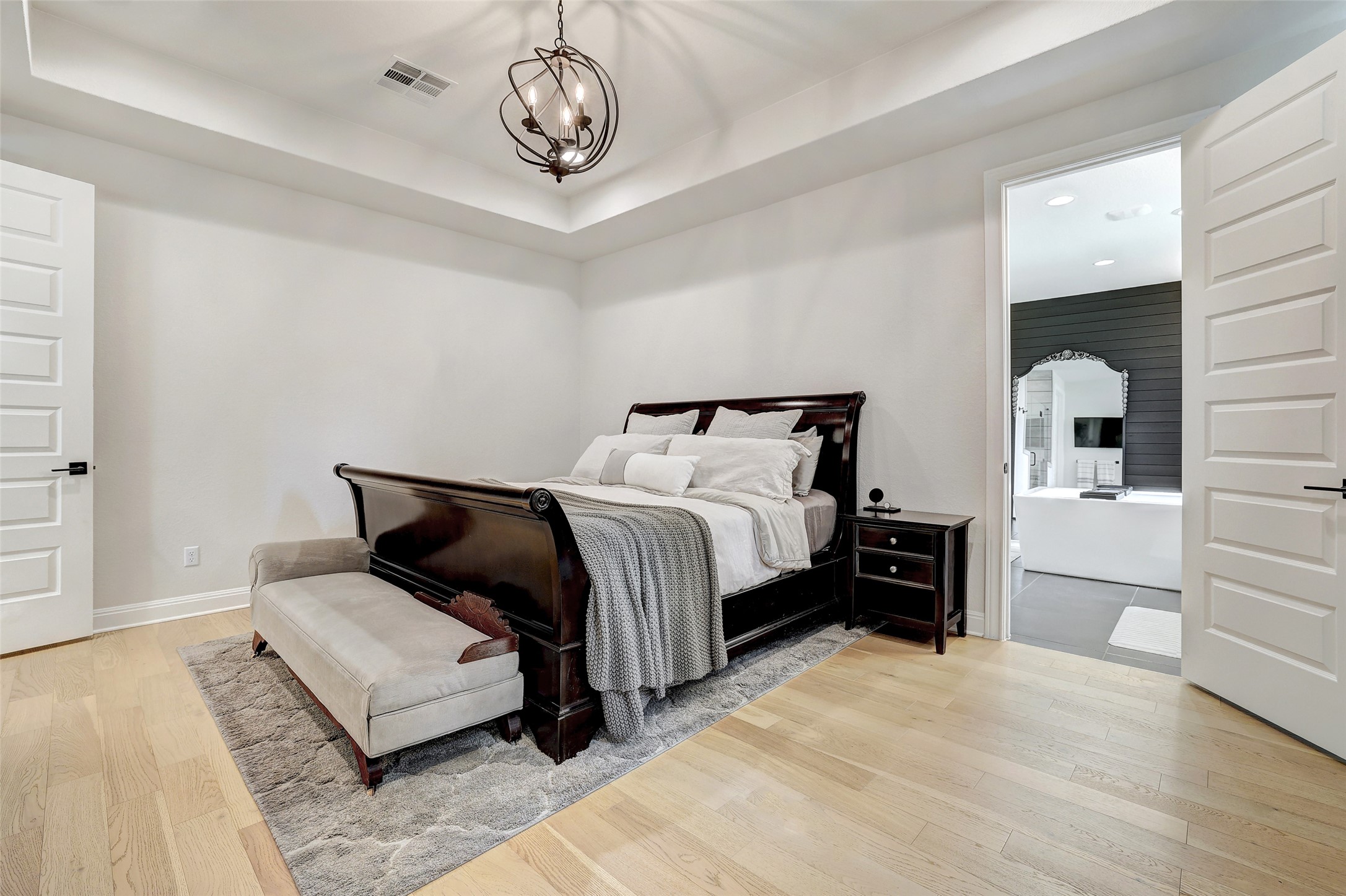 400 Flint Ridge Trail Georgetown, TX 78628 - Photo 16 of 40 Primary bedroom with light wood floors, a tray ceiling